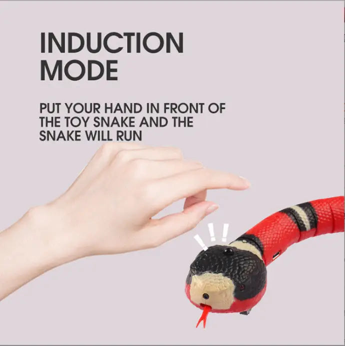 Hand activating induction mode on smart moving snake toy for cats, showcasing its interactive feature.